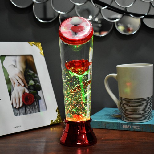 Beauty and the beast eternal rose flower floating in a snow glass bottle with multicolored LED lighting for this Valentines Day